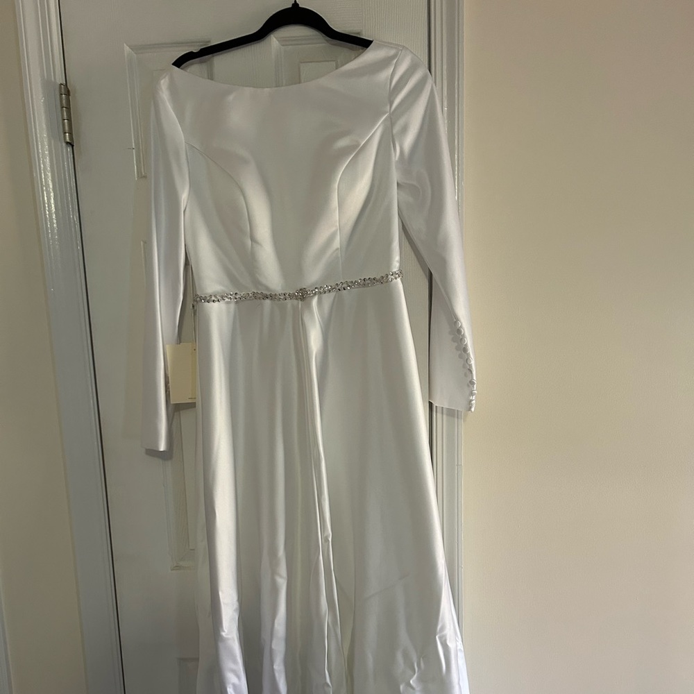 Wedding dress with tags. Rhinestone embellished at waist,real button closure.